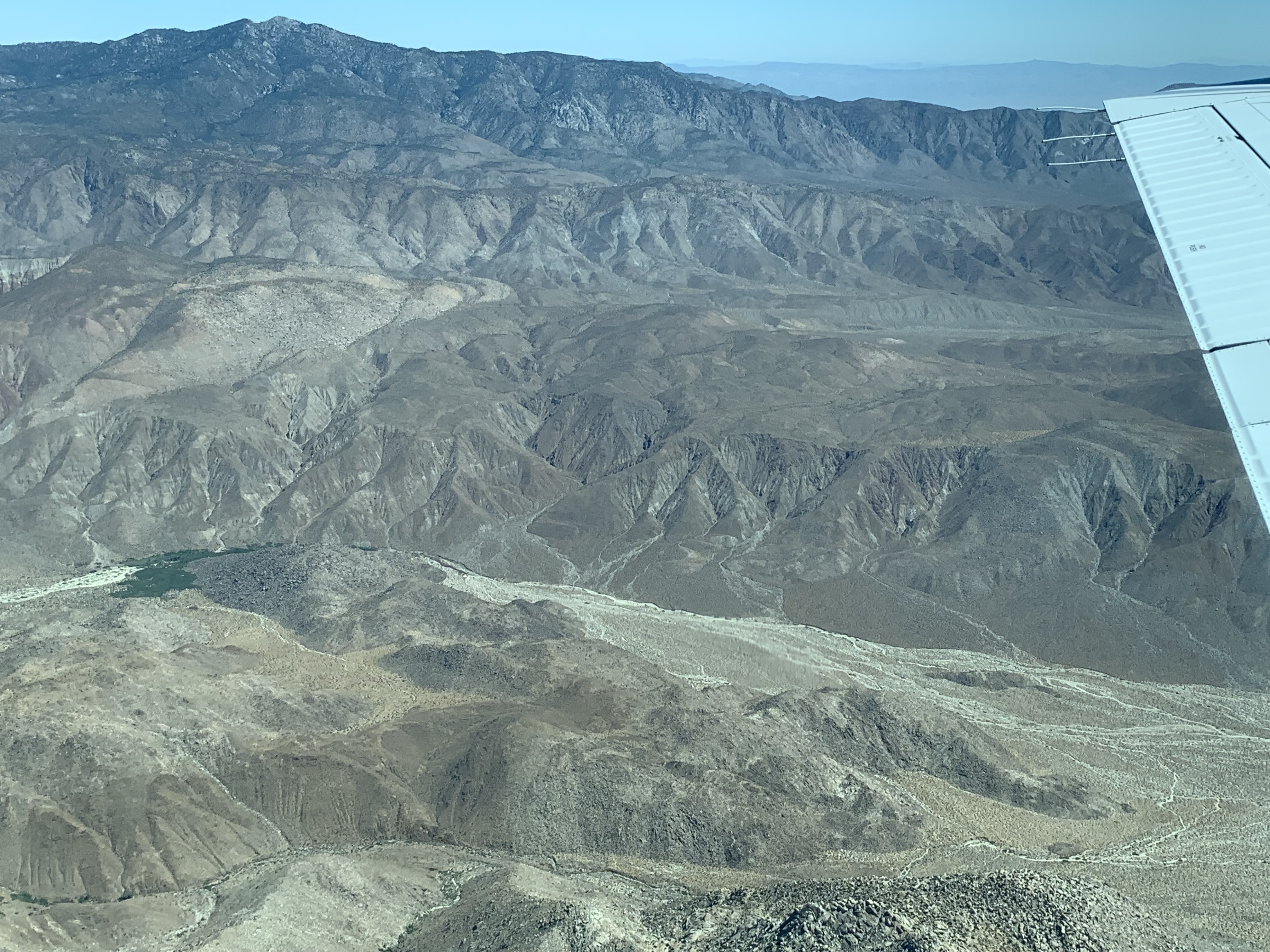 Aerial view of desert mountains and an alluvial valley.