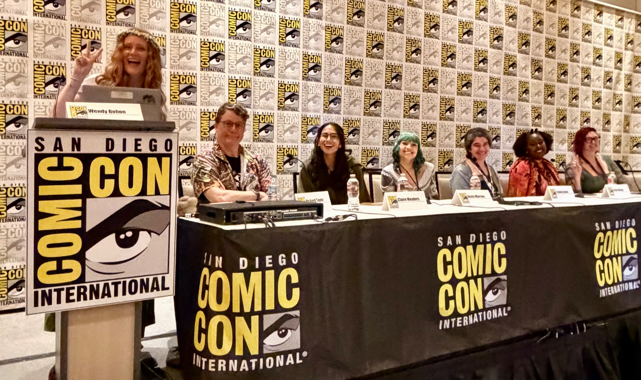 Wendy Bohon at the podium moderating a panel at San Diego Comic-Con in 2026.