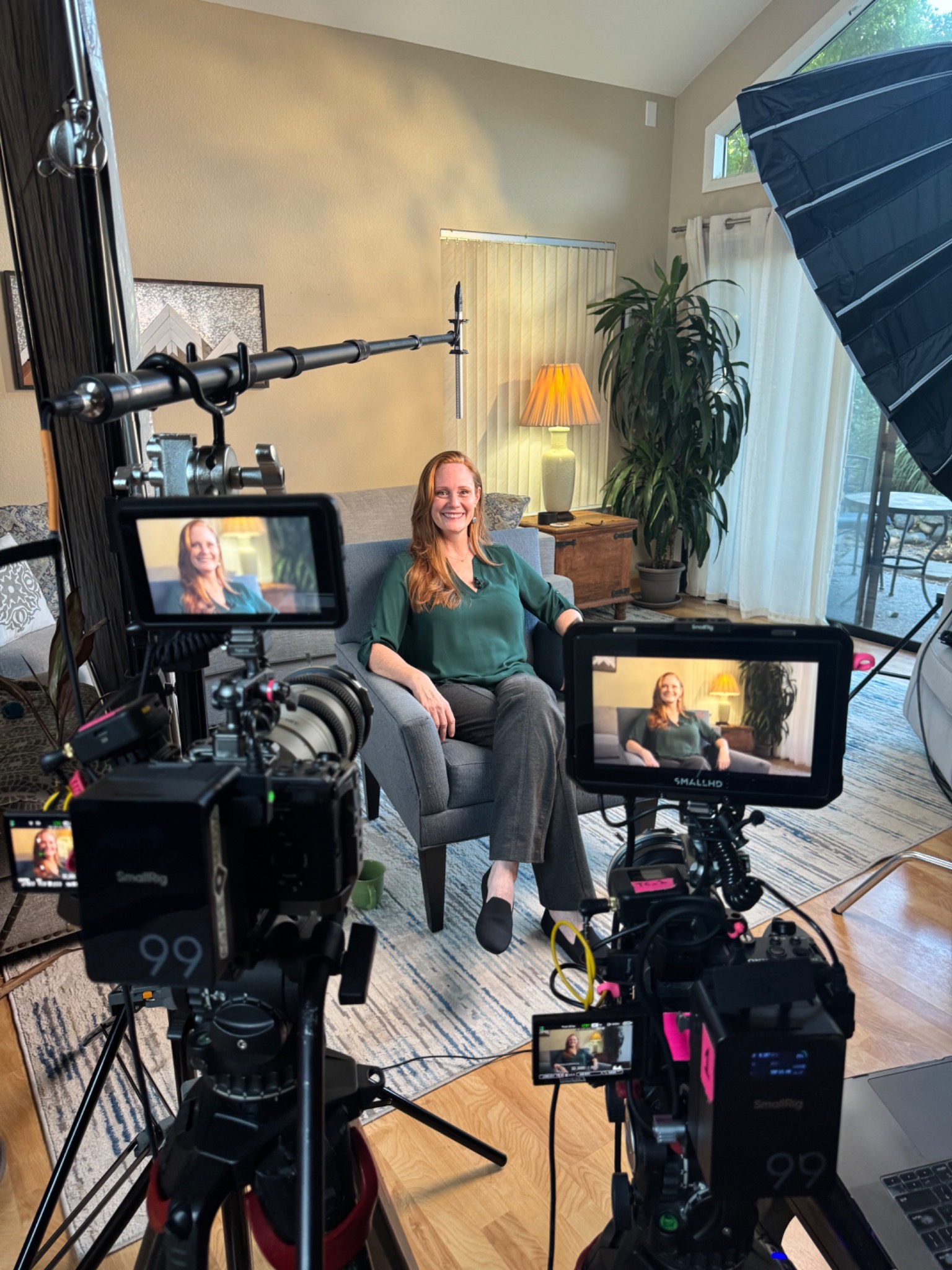 Wendy Bohon seated for a filmed interview, framed by cameras and monitors.